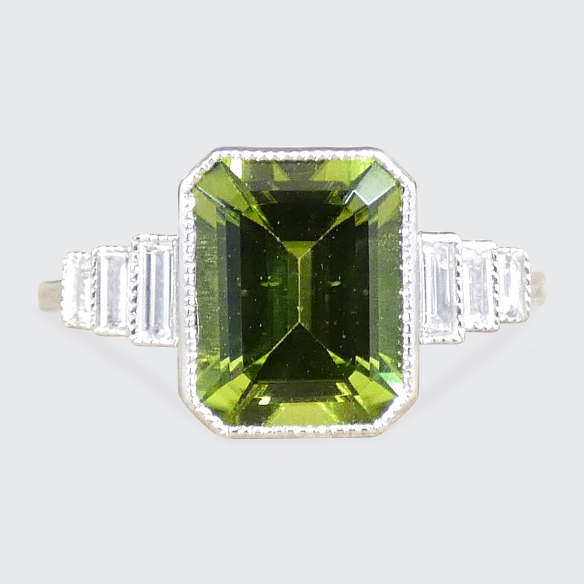 Art Deco Inspired Peridot and Baguette Cut Diamond Staged Shoulders in Platinum