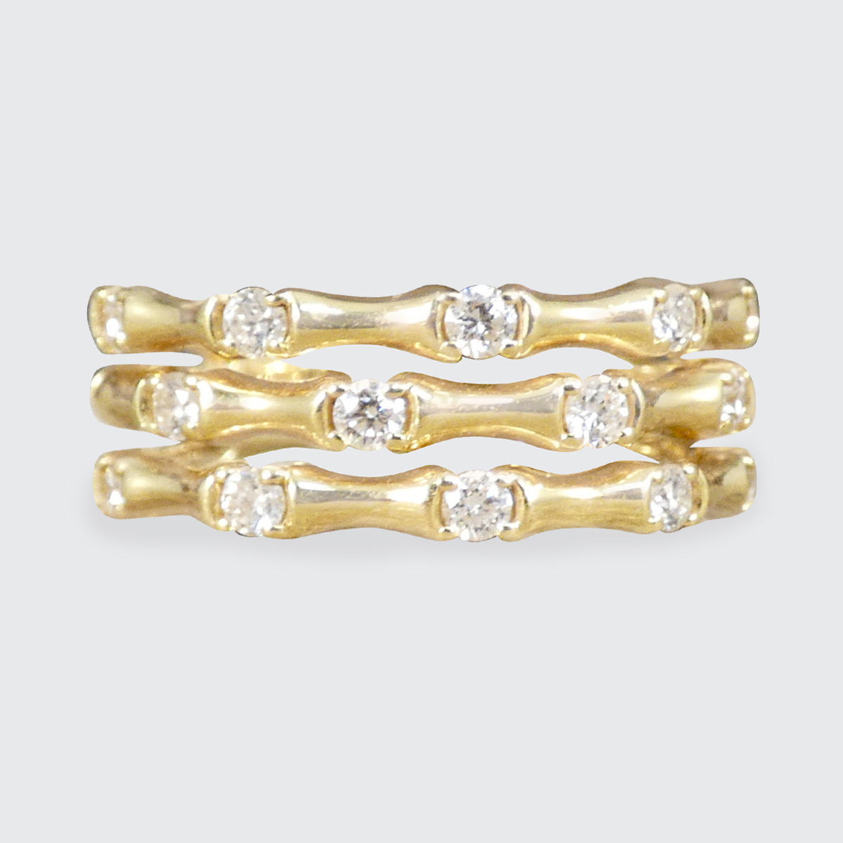 Three strand bamboo style ring in yellow gold with diamonds