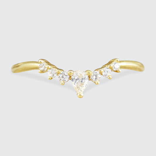 Gold ring with diamond-shaped stones on a light gray background