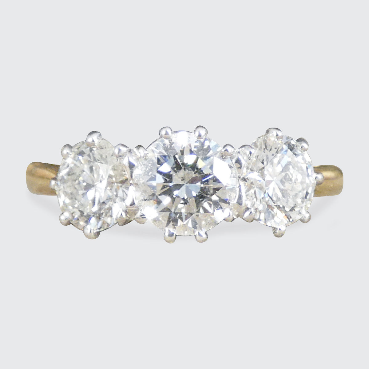 Diamond three stone ring in a platinum setting in 18ct yellow gold band