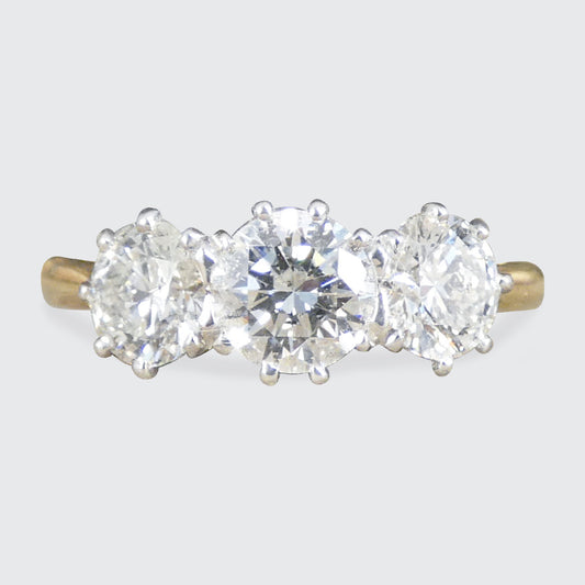 Diamond three stone ring in a platinum setting in 18ct yellow gold band