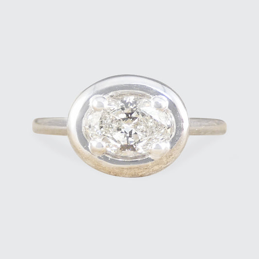 Oval Cut Diamond Ring in a chunky bezel setting set east west.