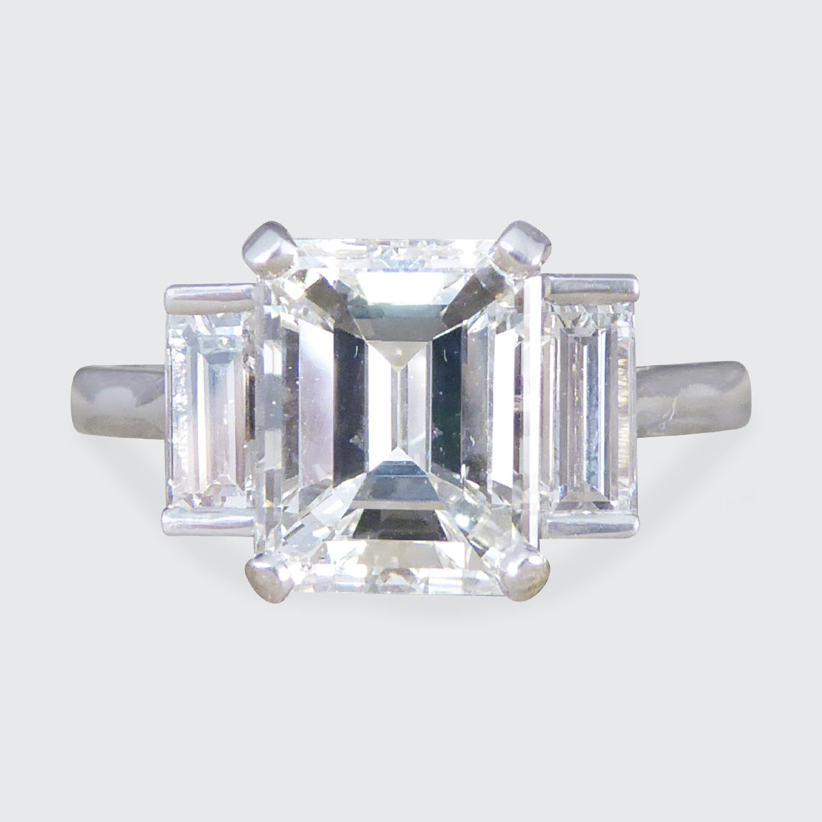 2.57ct Emerald and Baguette Cut Three Stone Ring in Platinum