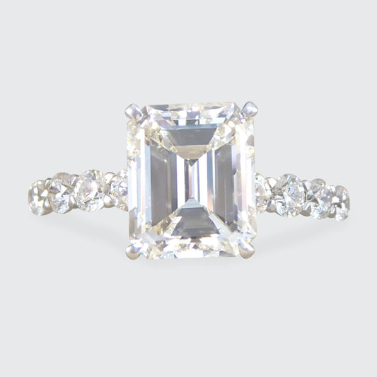 2.60ct Emerald Cut Diamond Solitaire Ring with 0.60ct Diamond Shoulders in Platinum - Wharfedale Antiques