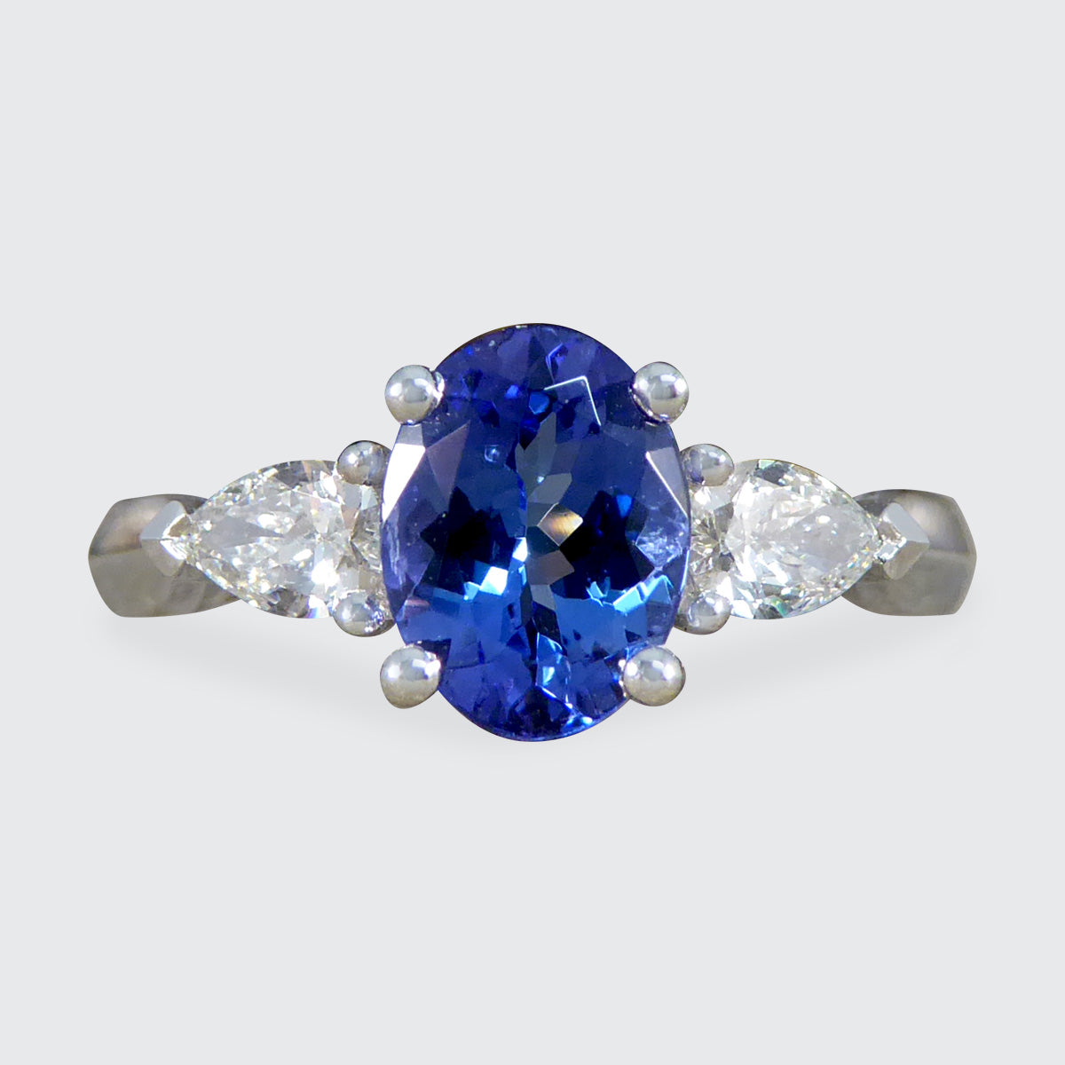 Oval Tanzanite and Pear Cut Diamond Three Stone Ring in Platinum - Wharfedale Antiques