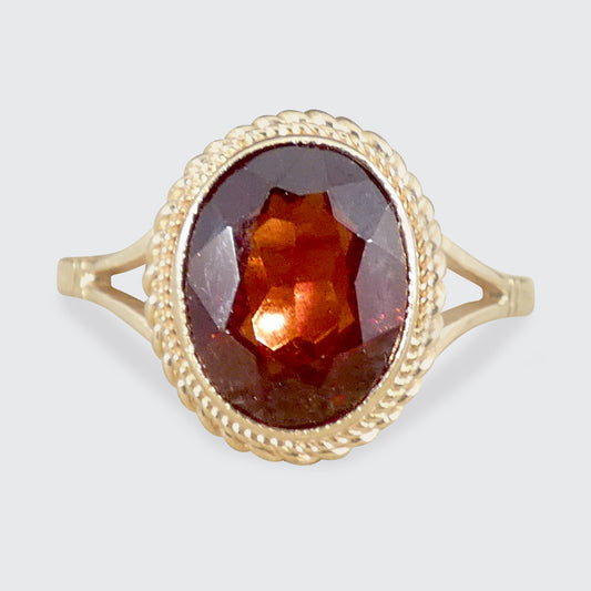A Garnet and Gold surround ring.