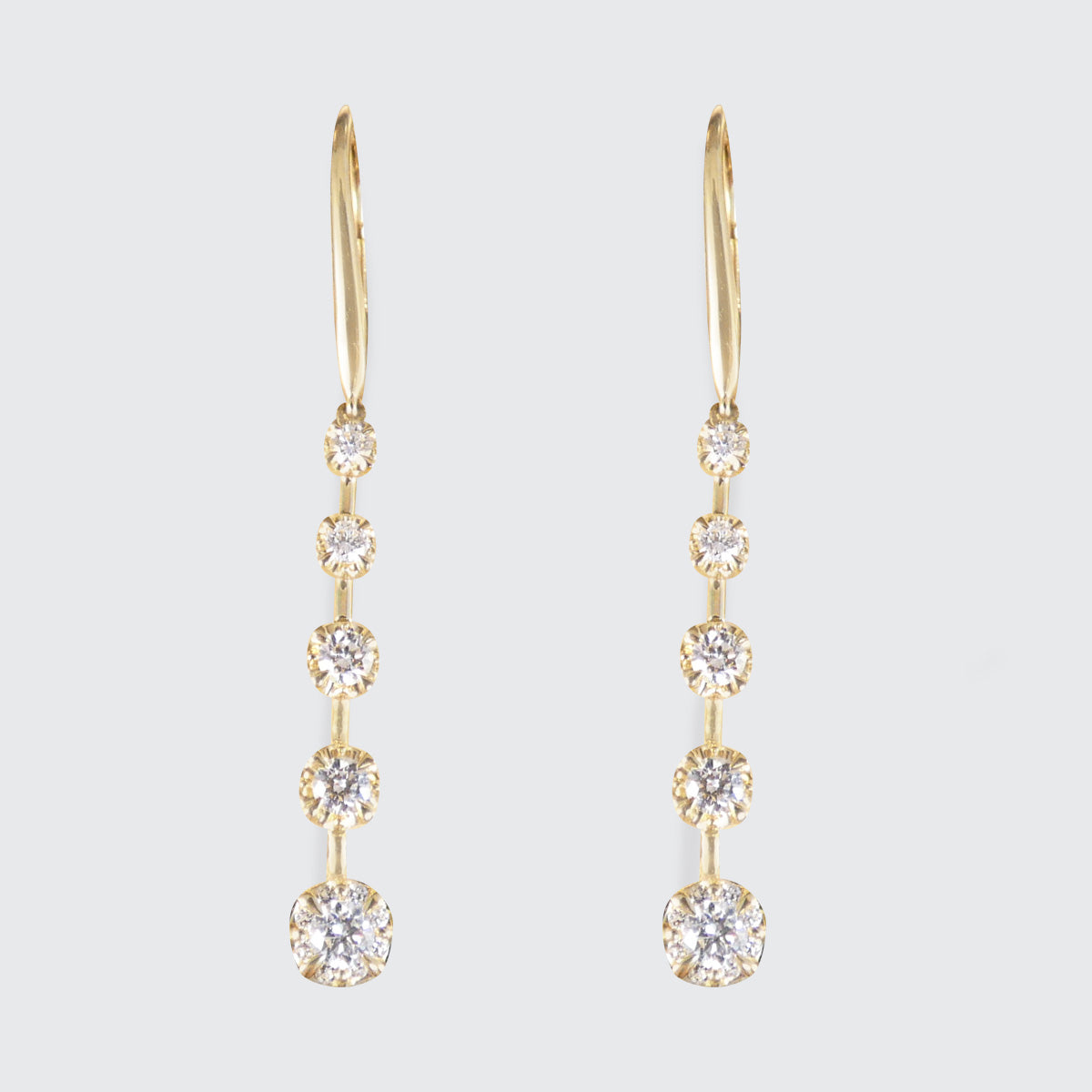 A pair of diamond drop earrings in 18ct yellow gold with a graduated drop.