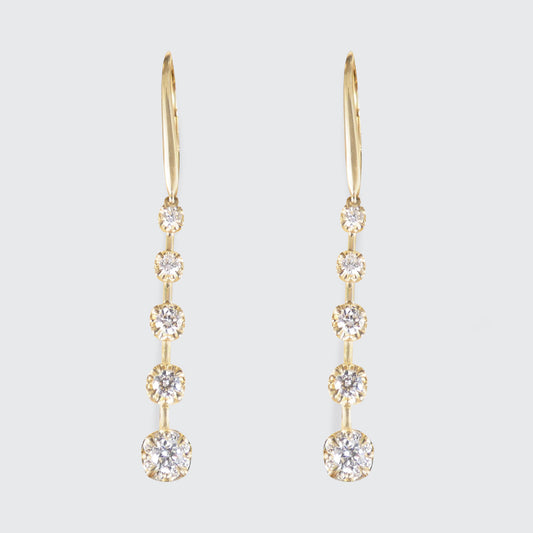 A pair of diamond drop earrings in 18ct yellow gold with a graduated drop.