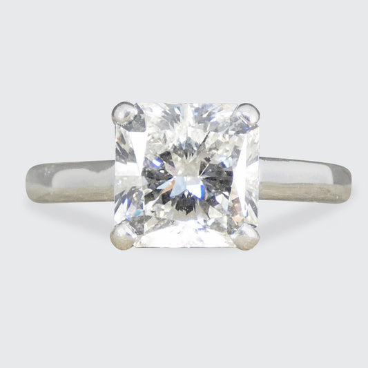 Diamond ring with a clear gemstone on a light gray background