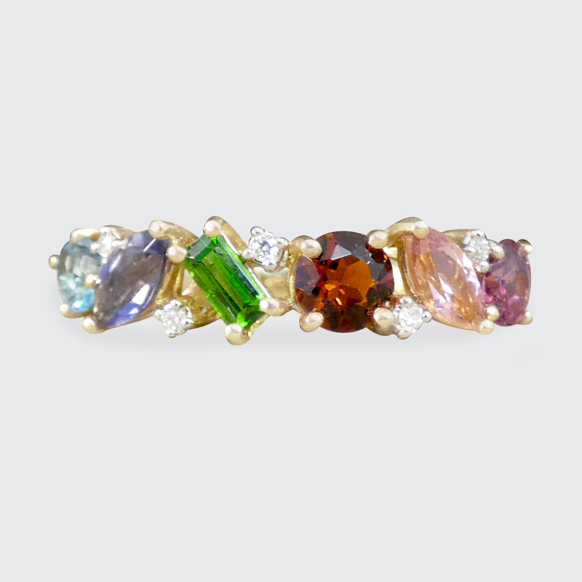 Multicolored gemstone ring with diamonds on a light gray background