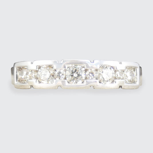 Diamond ring with five stones on a light gray background