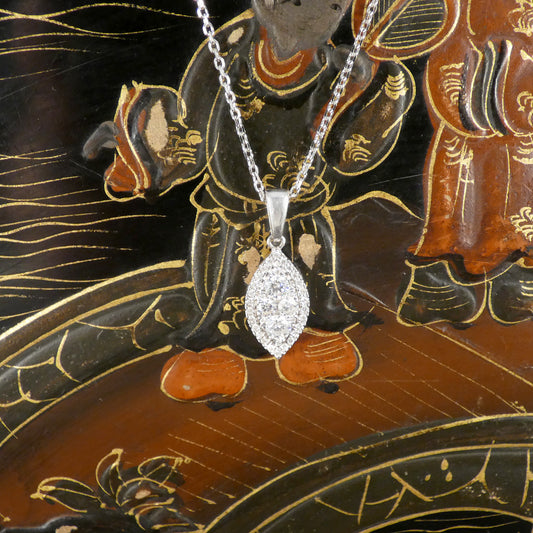 Diamond pendant necklace on a decorative background