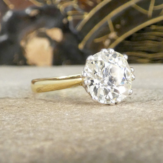 Gold ring with a large natural old cut diamond on a textured surface