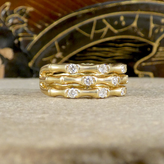 Three strand bamboo style ring in yellow gold with diamonds