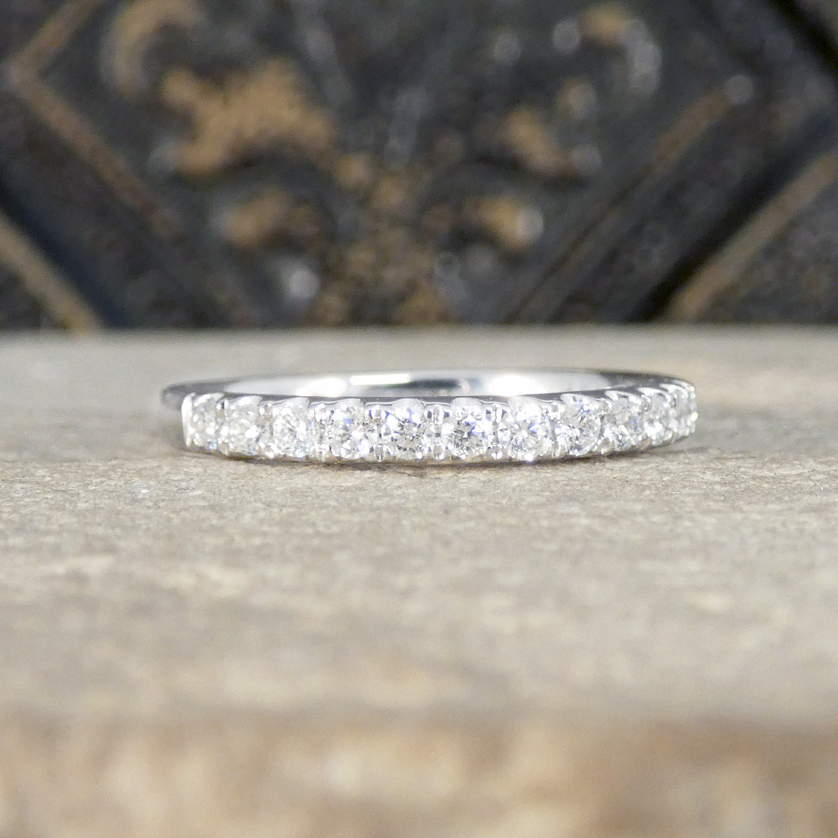 Platinum ring with small diamonds on a textured surface