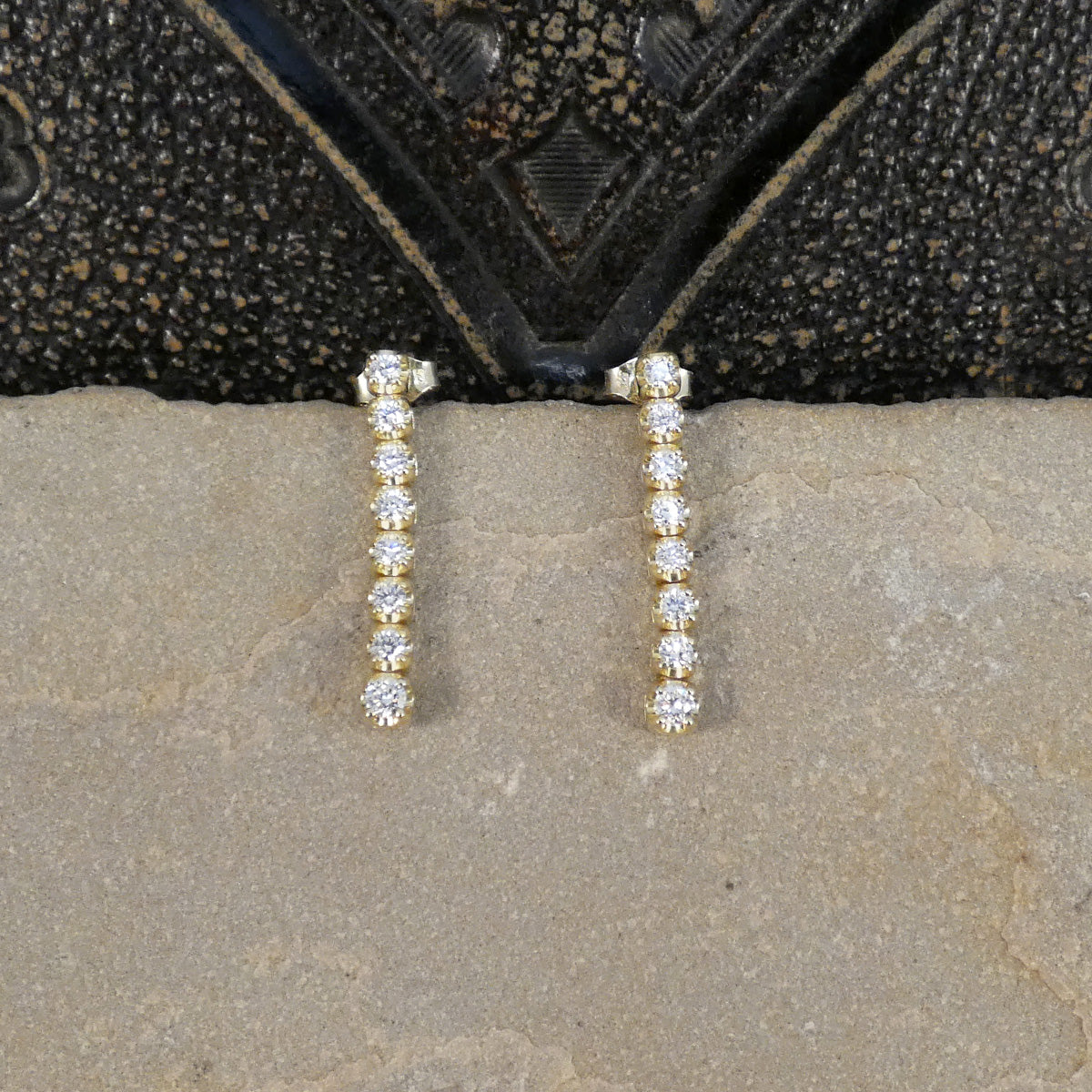 Diamond drop earring sin 9ct yellow gold on a stone.