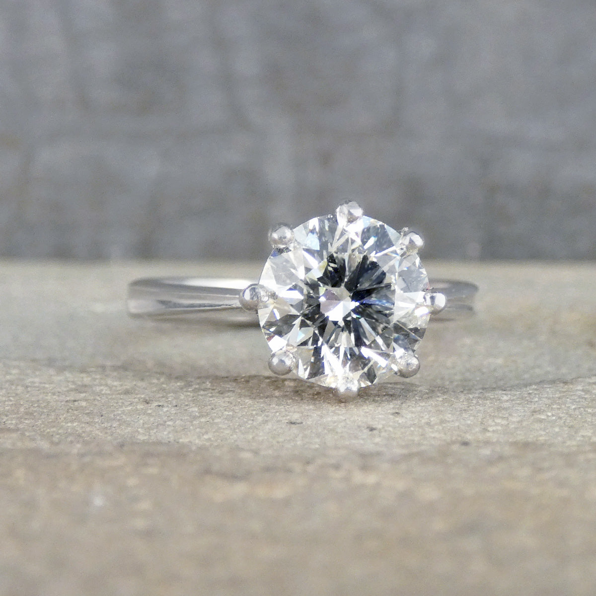 Diamond ring on a textured surface with a blurred background