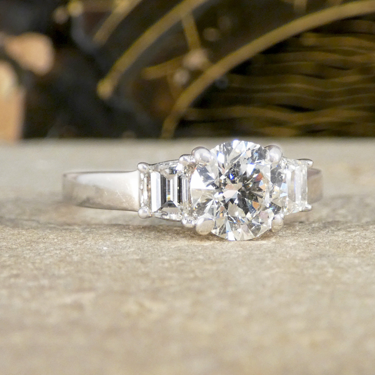 A brilliant cut and trapezoid cut Diamond three stone ring.