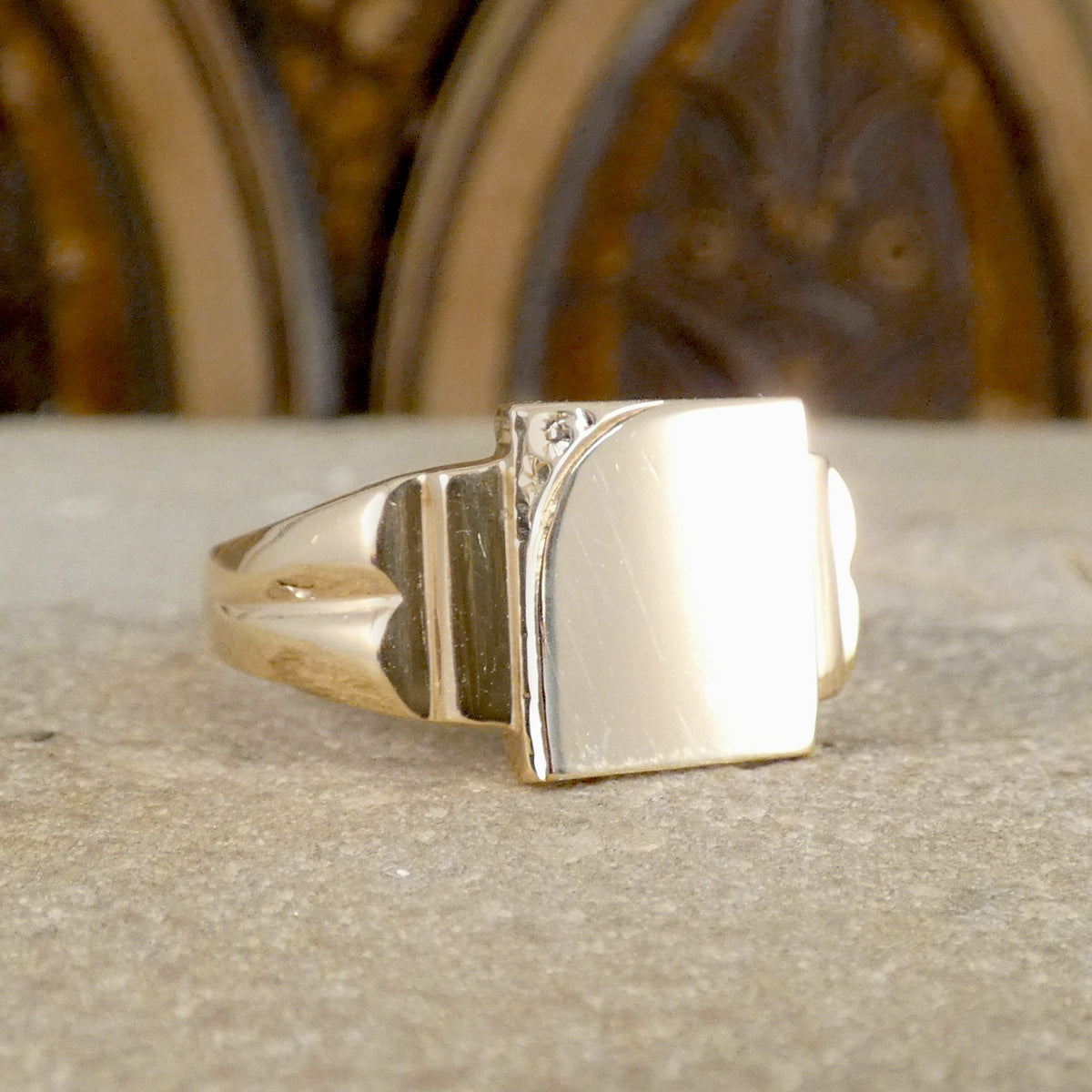 Gold ring on a textured surface with a blurred background