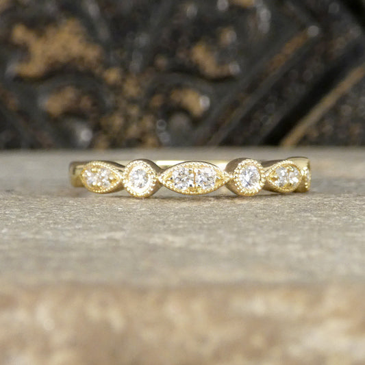 Gold ring with diamonds on a textured surface