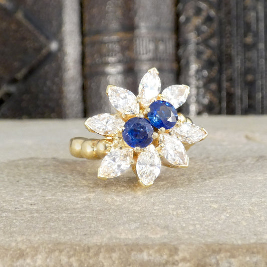 A gorgeous bright and beautiful Kutchinsky ring with Sapphires in the centre and surrounded by marquise cut diamonds in yellow gold.