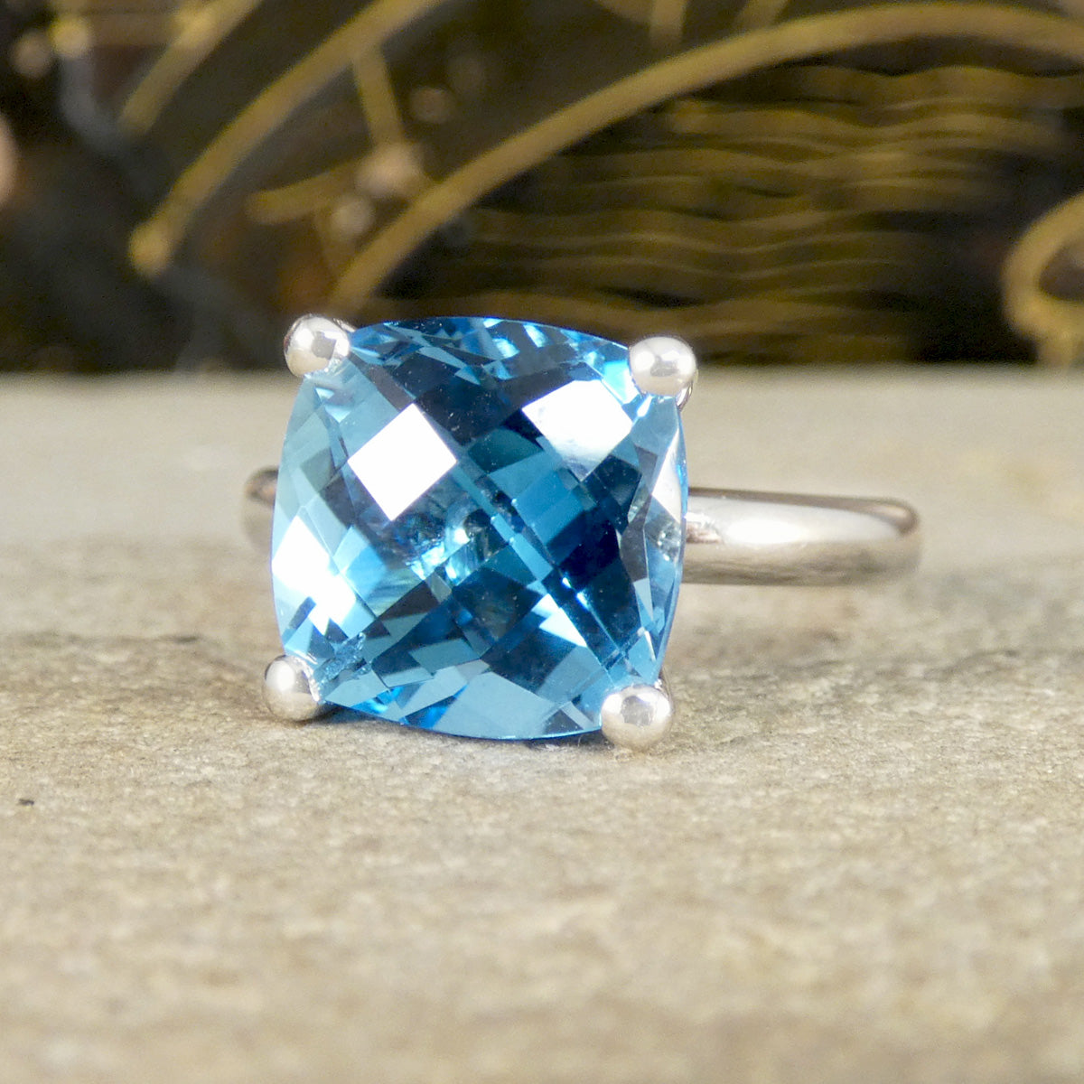 Ring with a blue gemstone on a textured surface