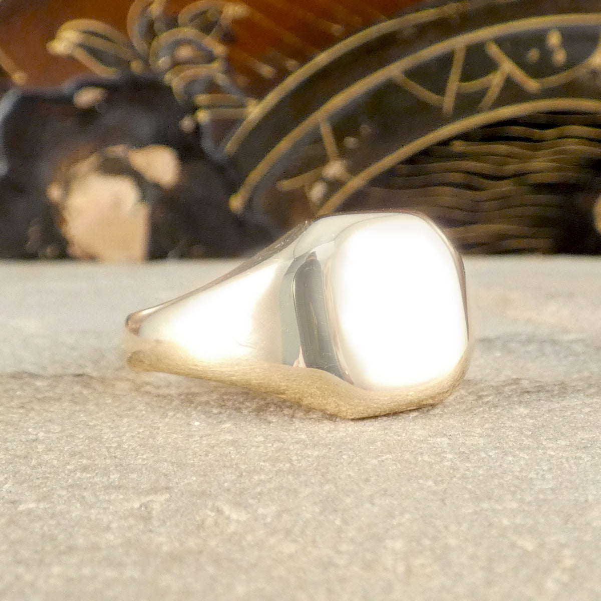 Gold ring on a textured surface with a blurred background
