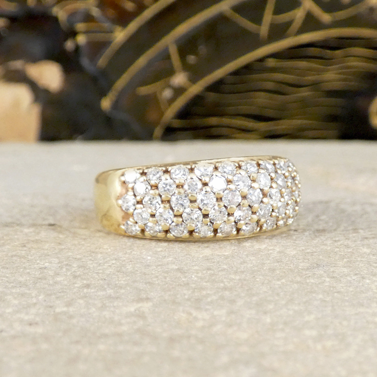 a diamond set domed ring in 9ct yellow gold