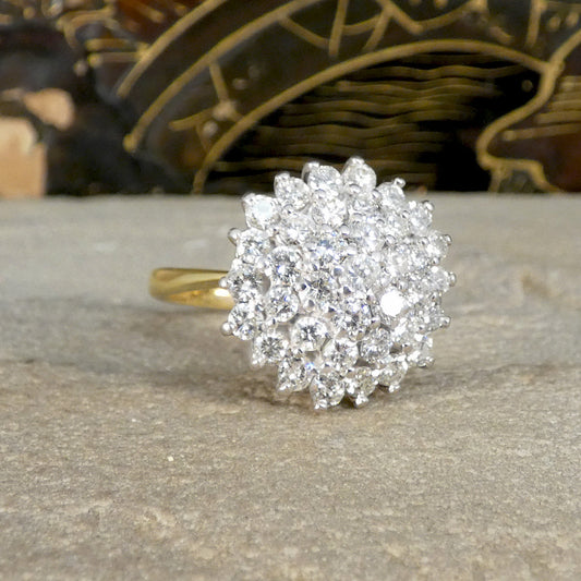 A big and beautiful diamond cluster ring on a yellow gold band.