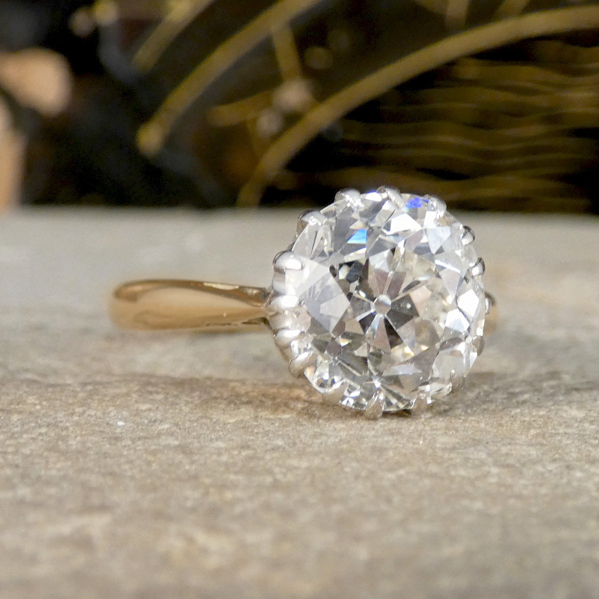 An Old Cushion shaped Mine cut diamond solitaire ring. 