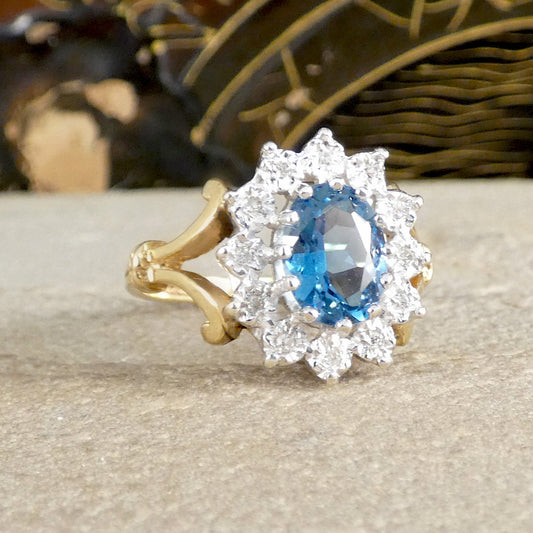 a flower cluster blue topaz and diamond cluster ring in yellow gold
