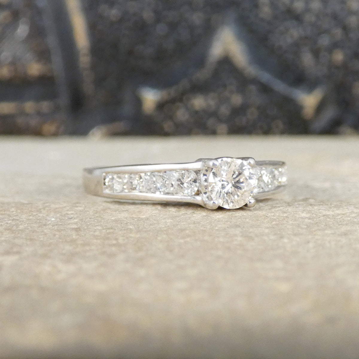 Diamond ring on a textured surface with a blurred background