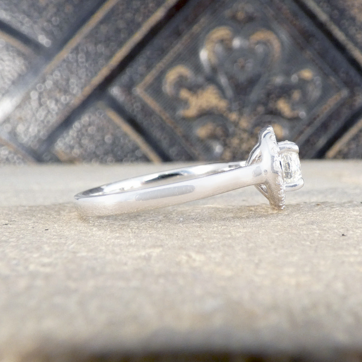 Side profile of diamond cluster ring with a wedfit design.
