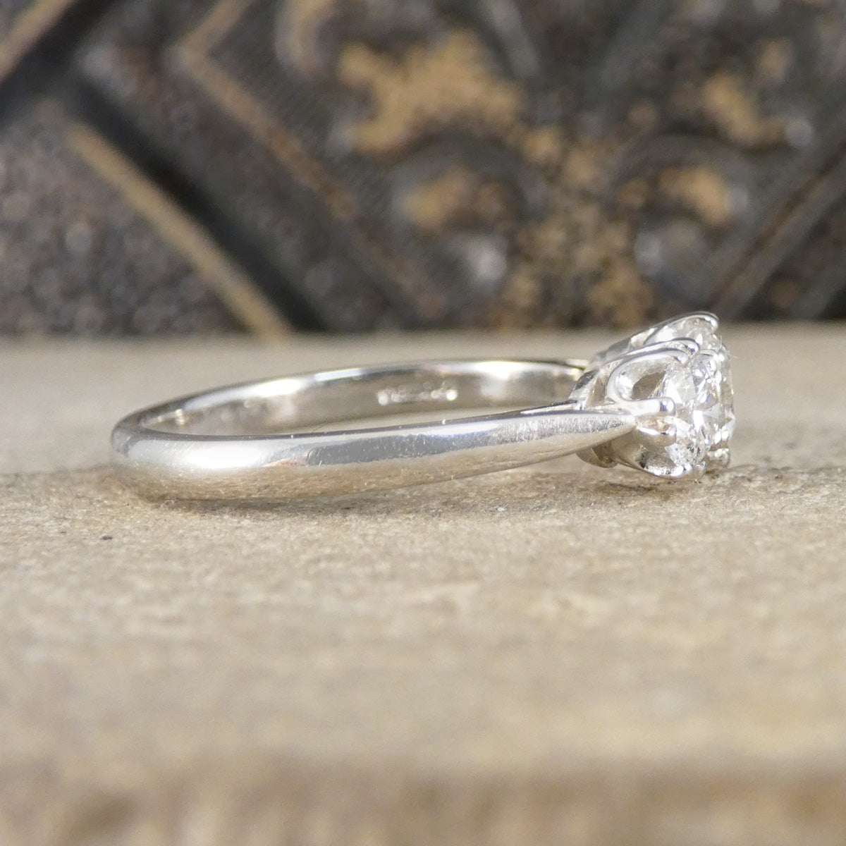 Silver ring with a diamond on a textured surface