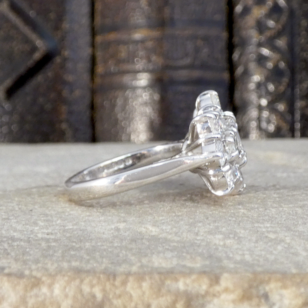 Side profile of diamond boat cluster ring showing plain polished band.