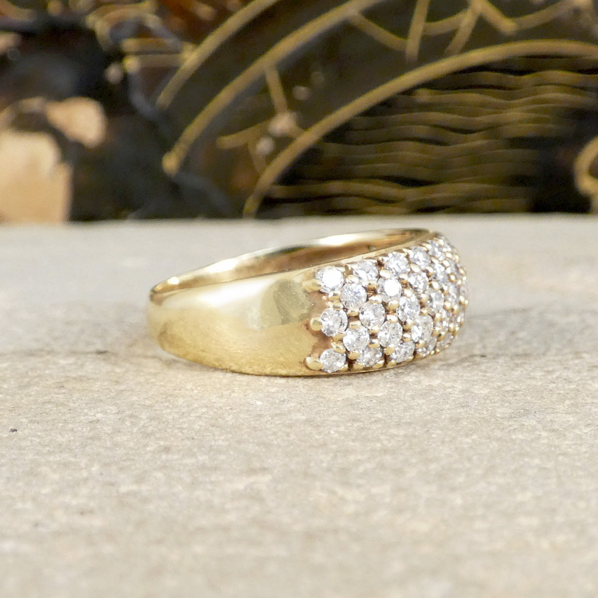 side profile of domed diamond set ring in yellow gold