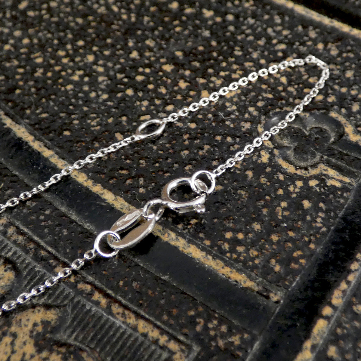 The platinum chain with a sade bolt ring clasp and two lengths at 16" and 18".