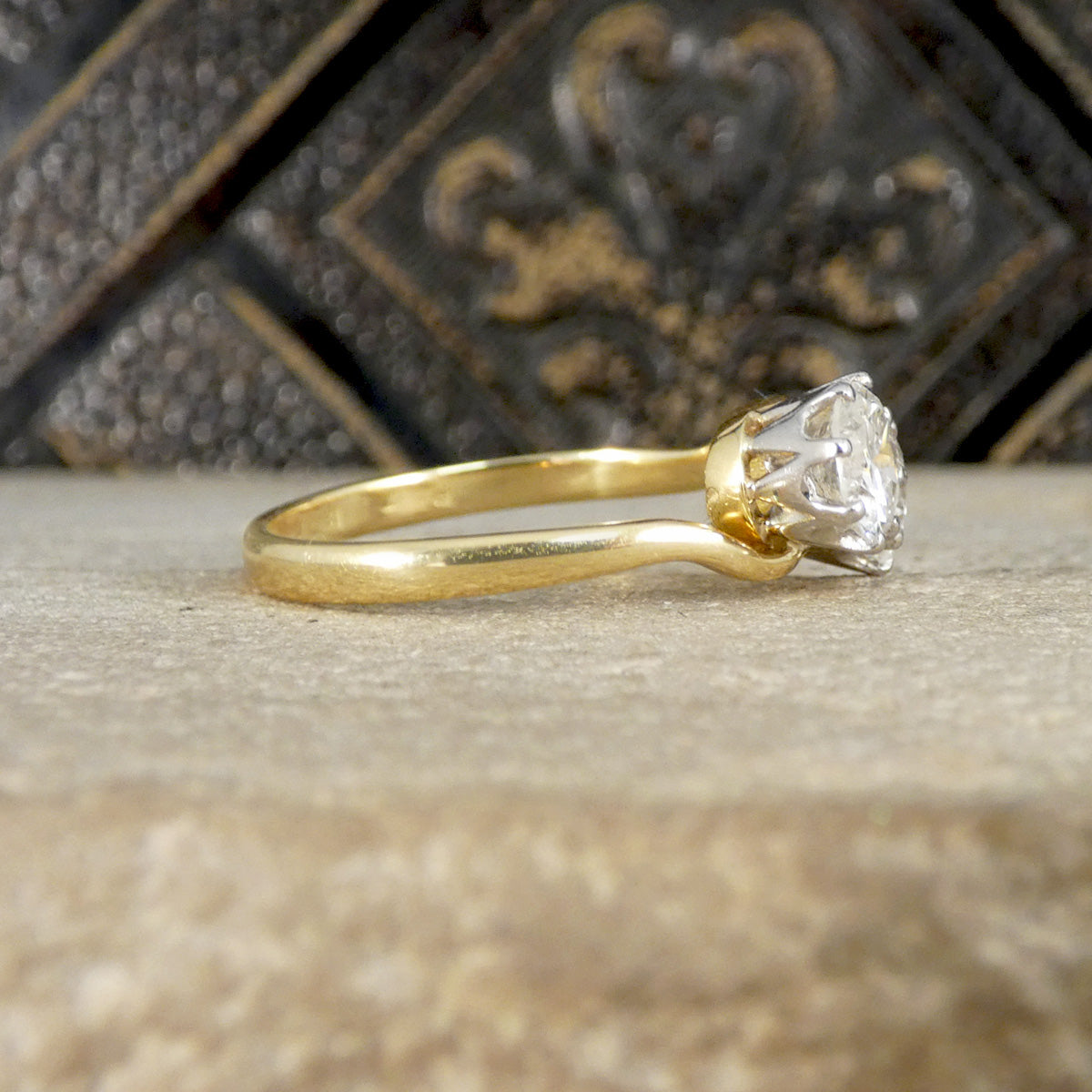 side view of diamond ring in yellow gold and plat