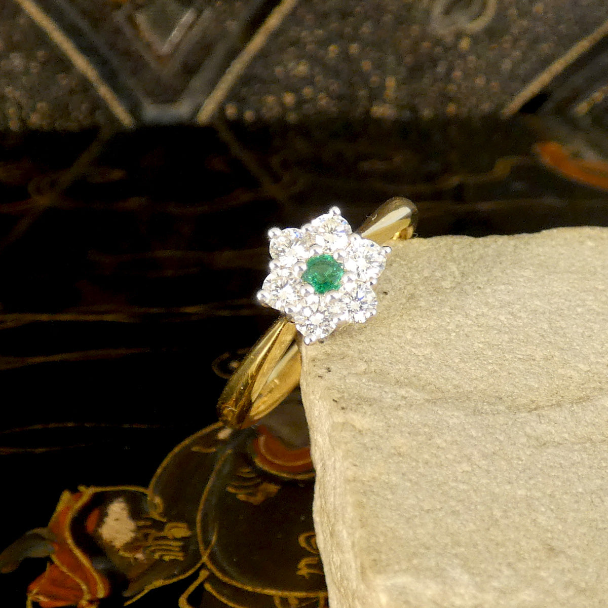 A beautiful and dainty Emerald and Diamond flower cluster ring in 18ct Yellow and White Gold. The stones have a bright and lively presence.