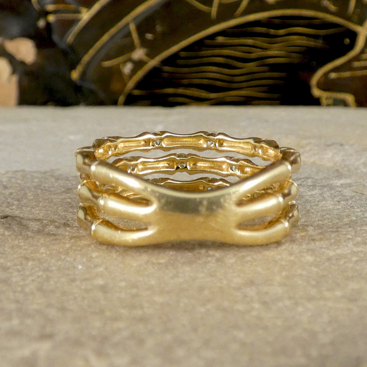 Back view of three strand bamboo style ring in yellow gold with diamonds