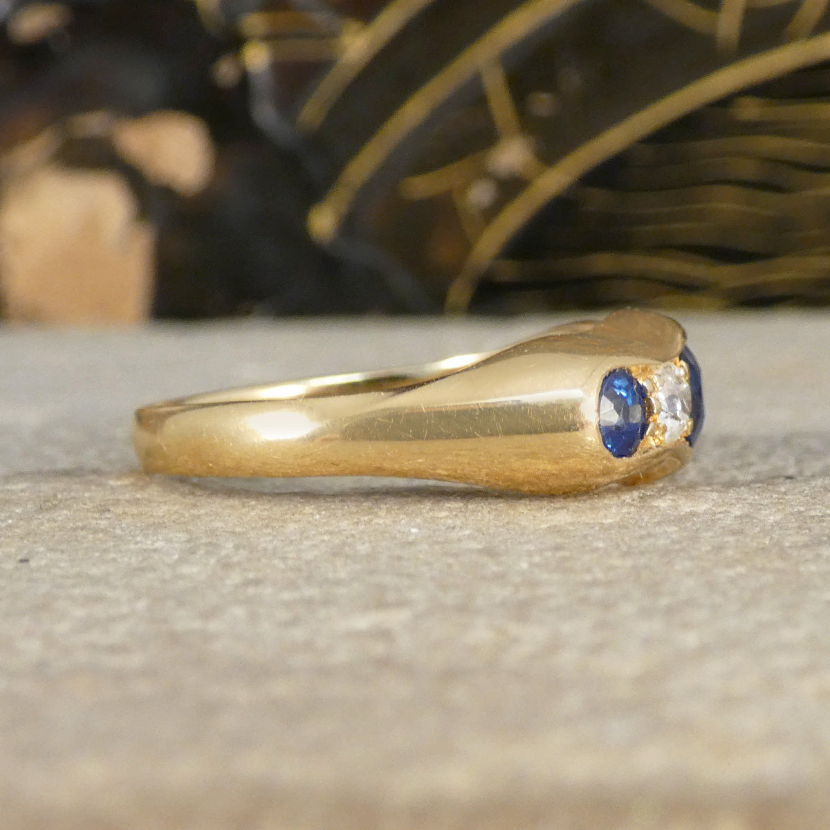 Side profile of sapphire and diamond five stone ring.