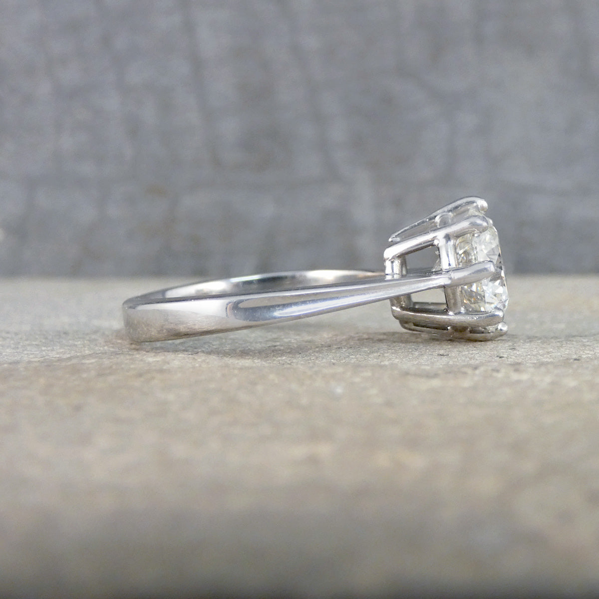 White Gold ring with a diamond on a textured surface