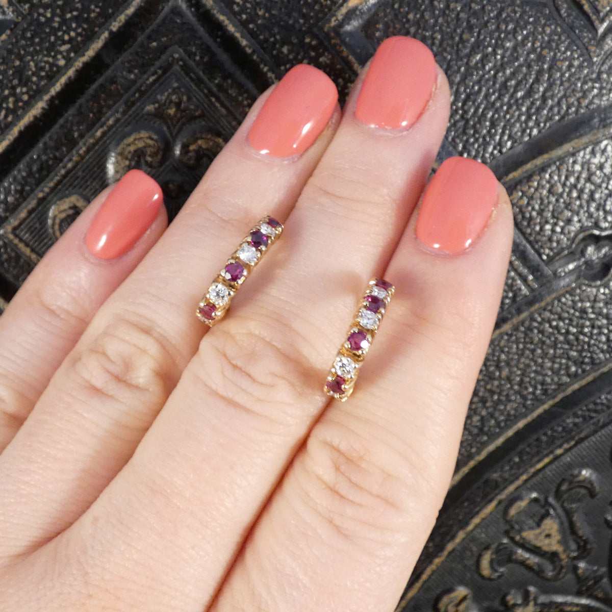 Ruby and Diamond Huggie Earrings in Yellow Gold shown on the hand 