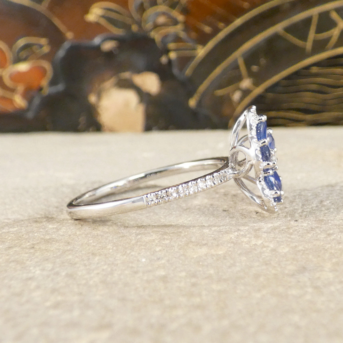 Sapphire and Diamond flower cluster ring in 18ct white gold with diamond set shoulders