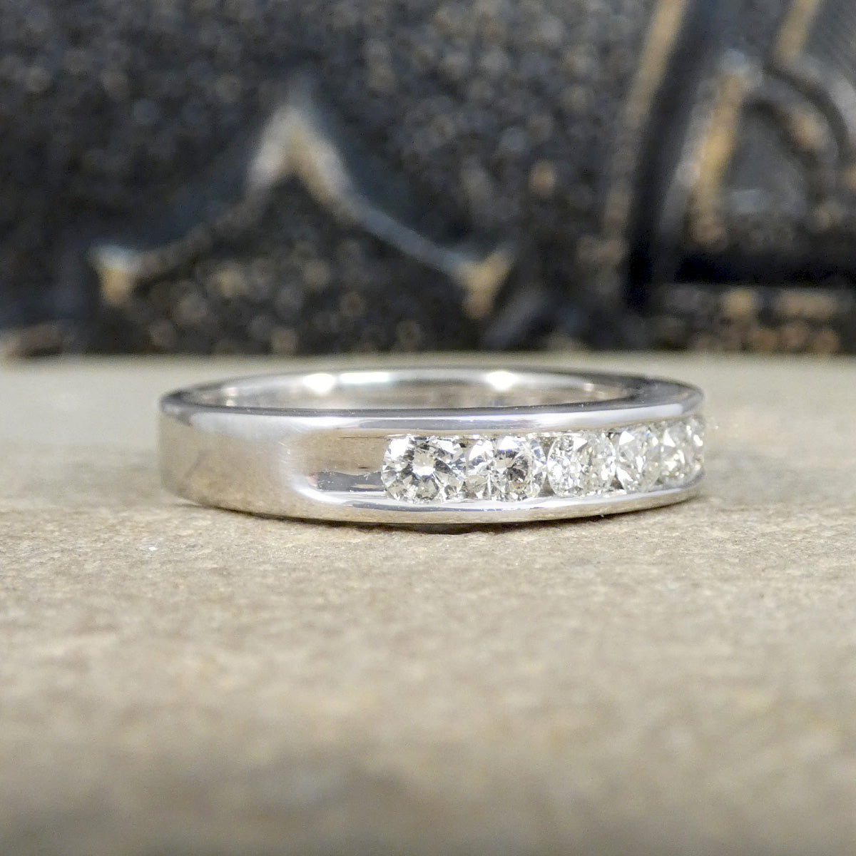 White Gold ring with embedded diamonds on a textured surface