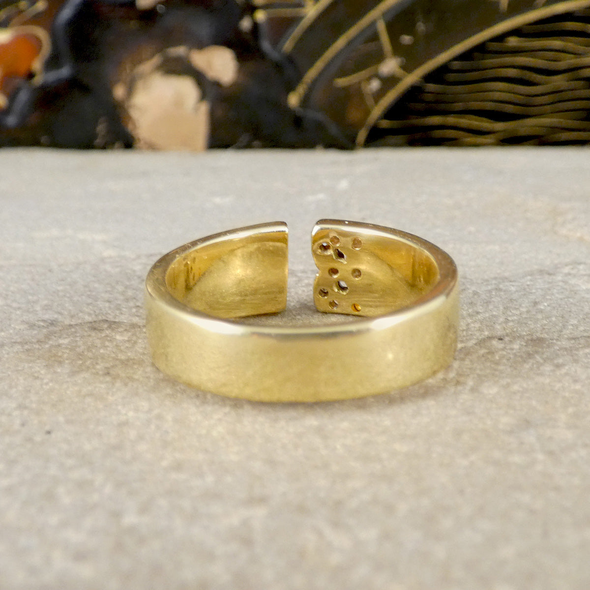 Gold split ring on a textured surface with blurred background