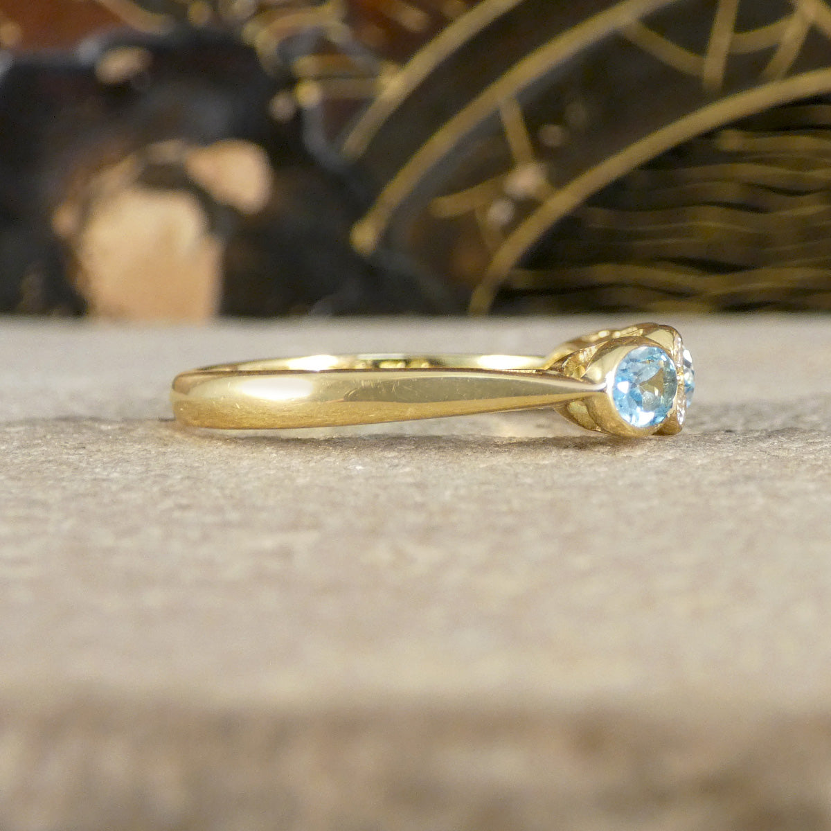 side view of Blue Topaz and Diamonds ring in Yellow Gold