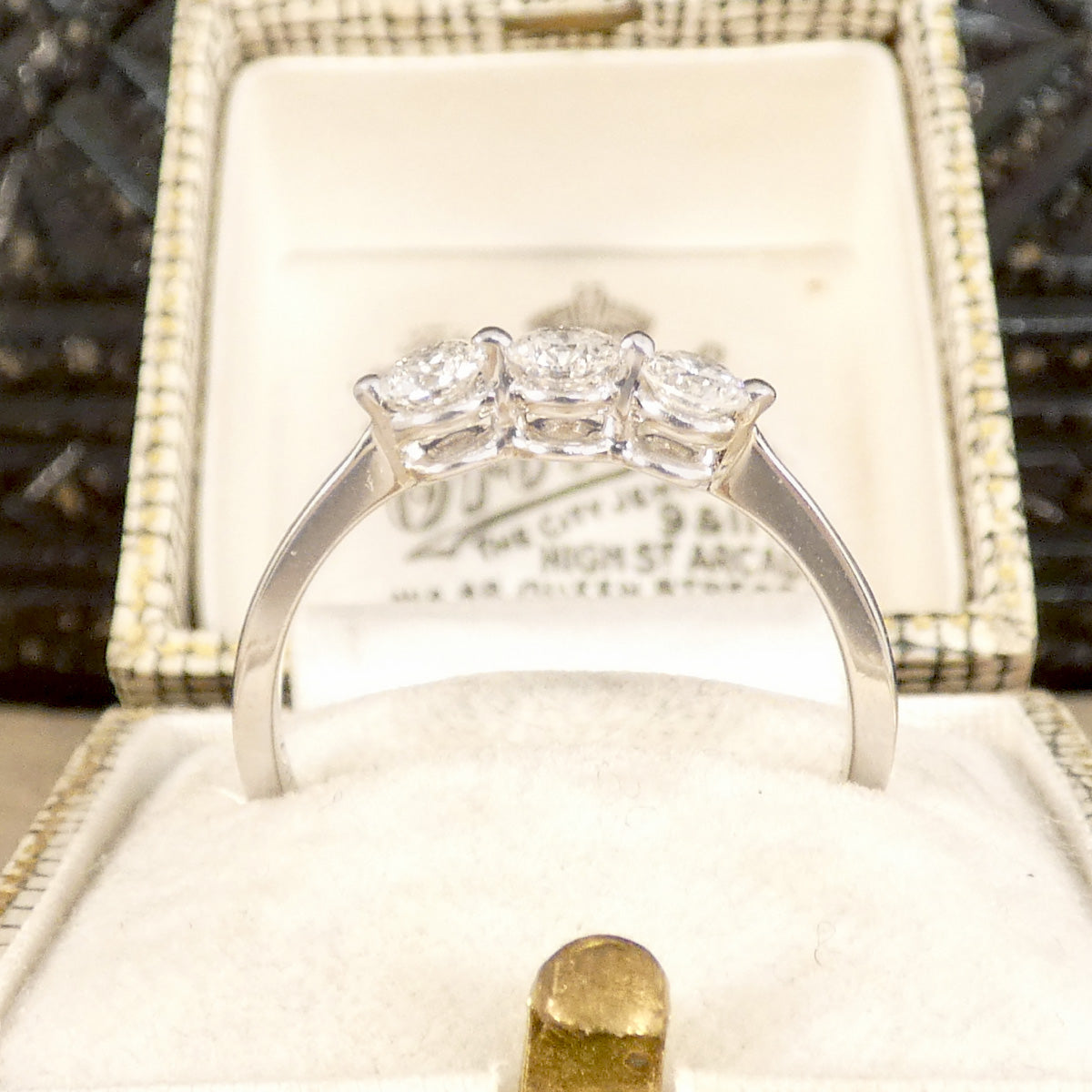 Side profile of diamond three stone ring in 18ct white gold.