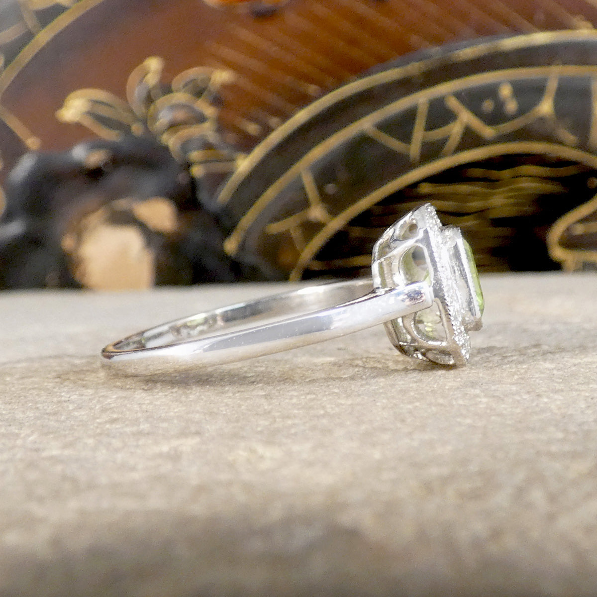 Side view of Art Deco Style Peridot and Diamond Cluster Ring in Platinum.