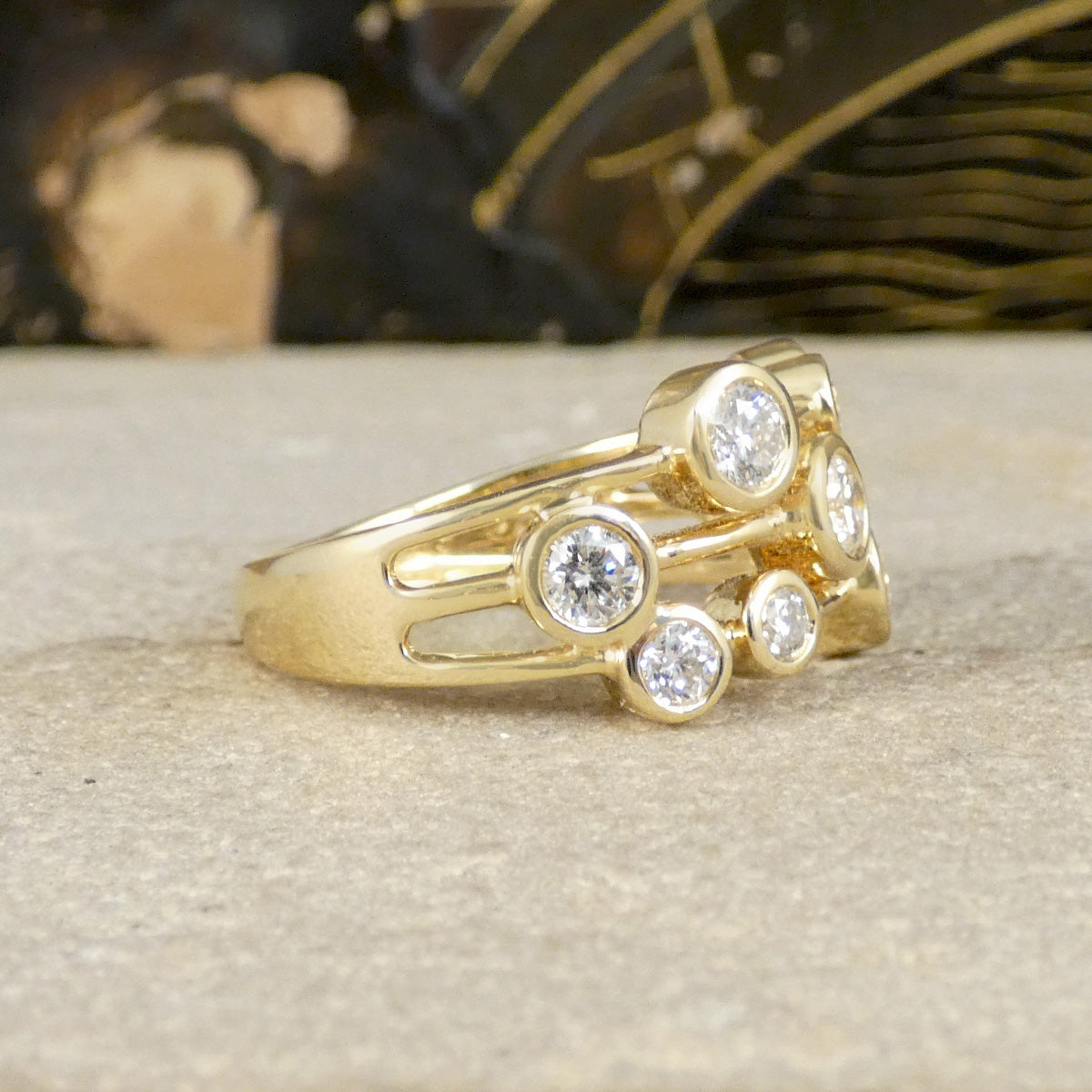 Gold ring with diamond stones on a textured surface